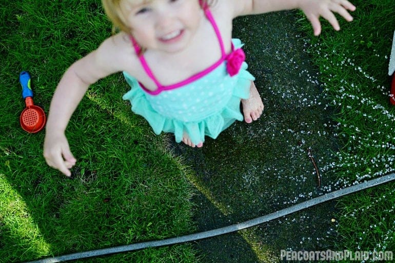 Playing in the sprinkler.