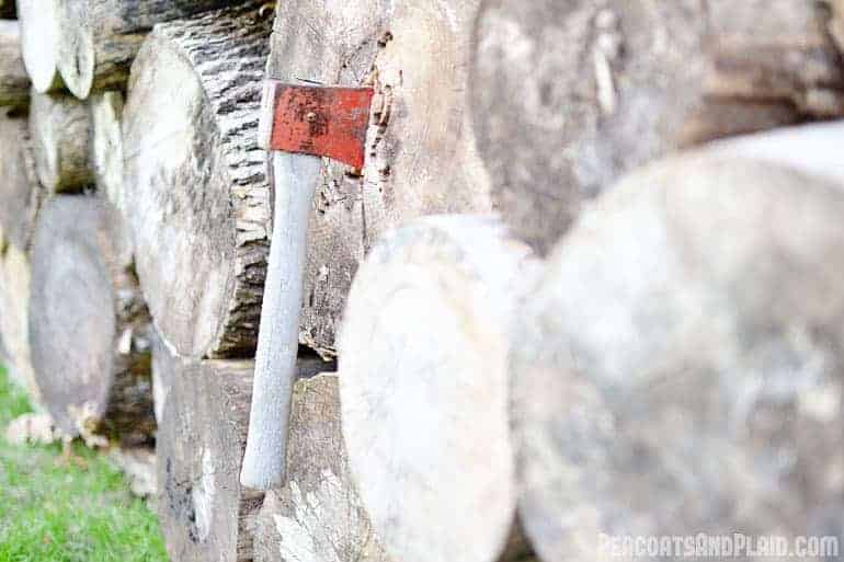 Axe in a pile of cut logs.