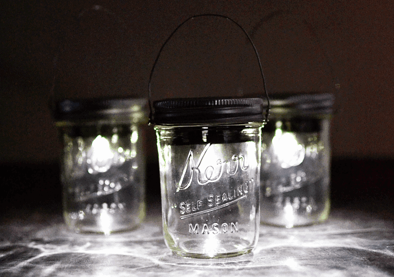 Make these Mason Jar Hanging Solar Lanterns using just a few supplies: mason jars and solar lights!