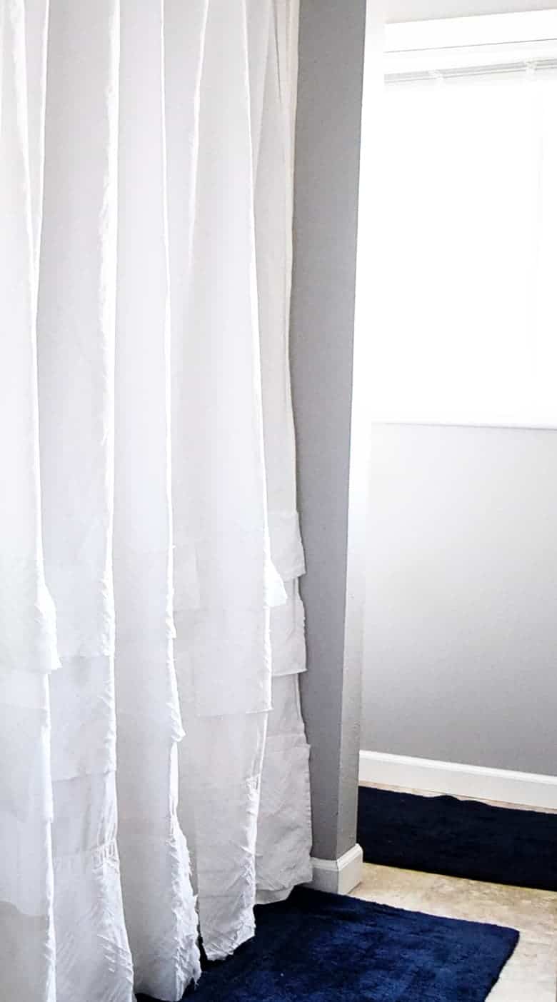 Take a commonly found white thrift store sheet and turn it into this boho high end knock off with this easy DIY shower curtain!
