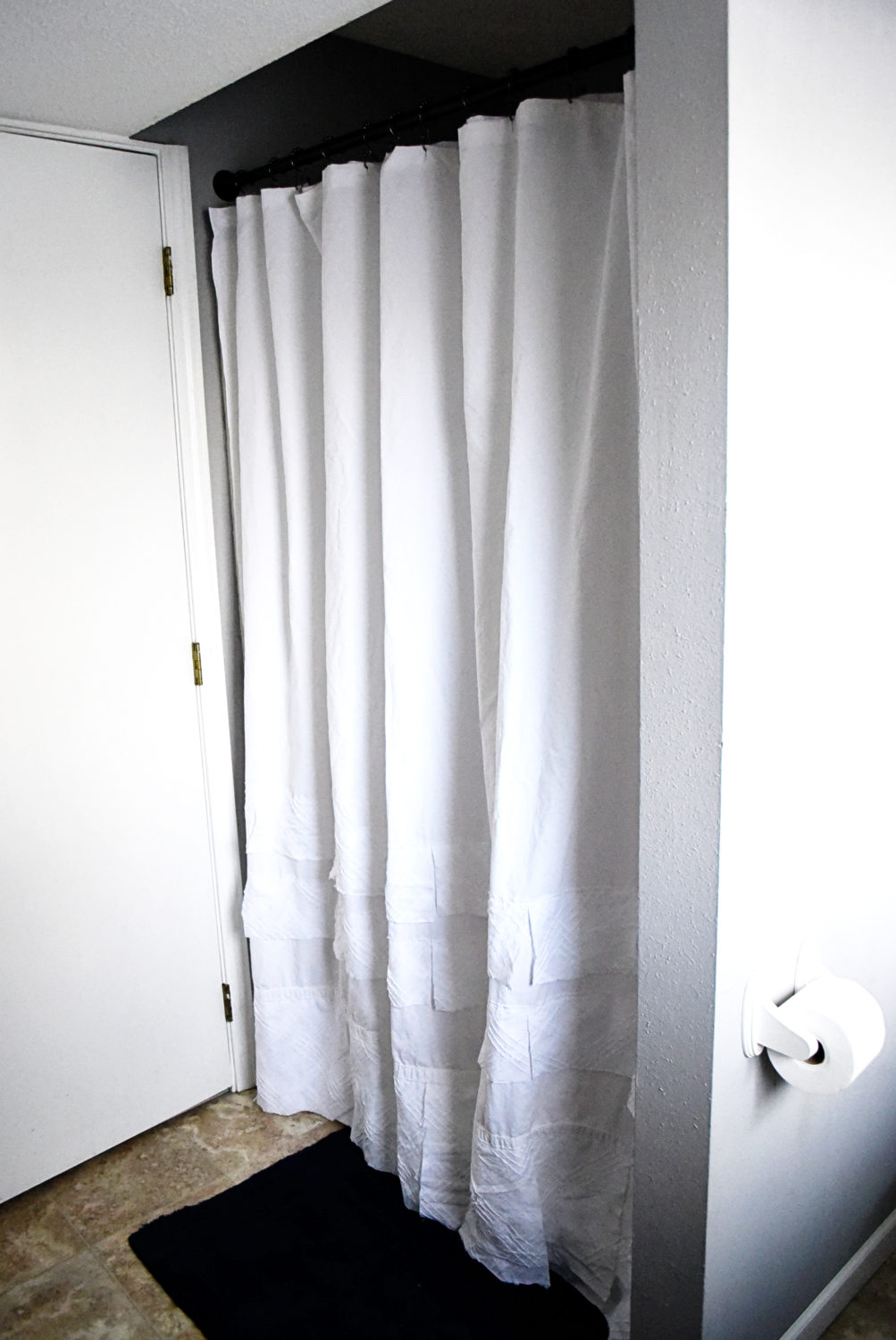 Take a commonly found white thrift store sheet and turn it into this boho high end knock off with this easy DIY shower curtain!