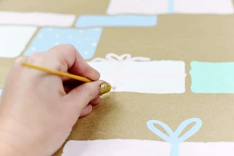 Make this durable and cute, easy DIY wrapping paper that's perfect for Christmas! All you need is a roll of brown kraft paper and some stencils.