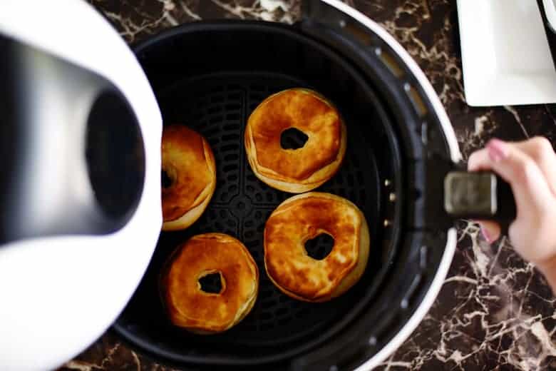 If you're looking for air fryer recipes, this donut recipe is SO quick, easy, and delicious! Plus, they only take 5 minutes to make. You can make them glazed or top them with cinnamon and sugar or powdered sugar. Also includes a free printable gift tag! 