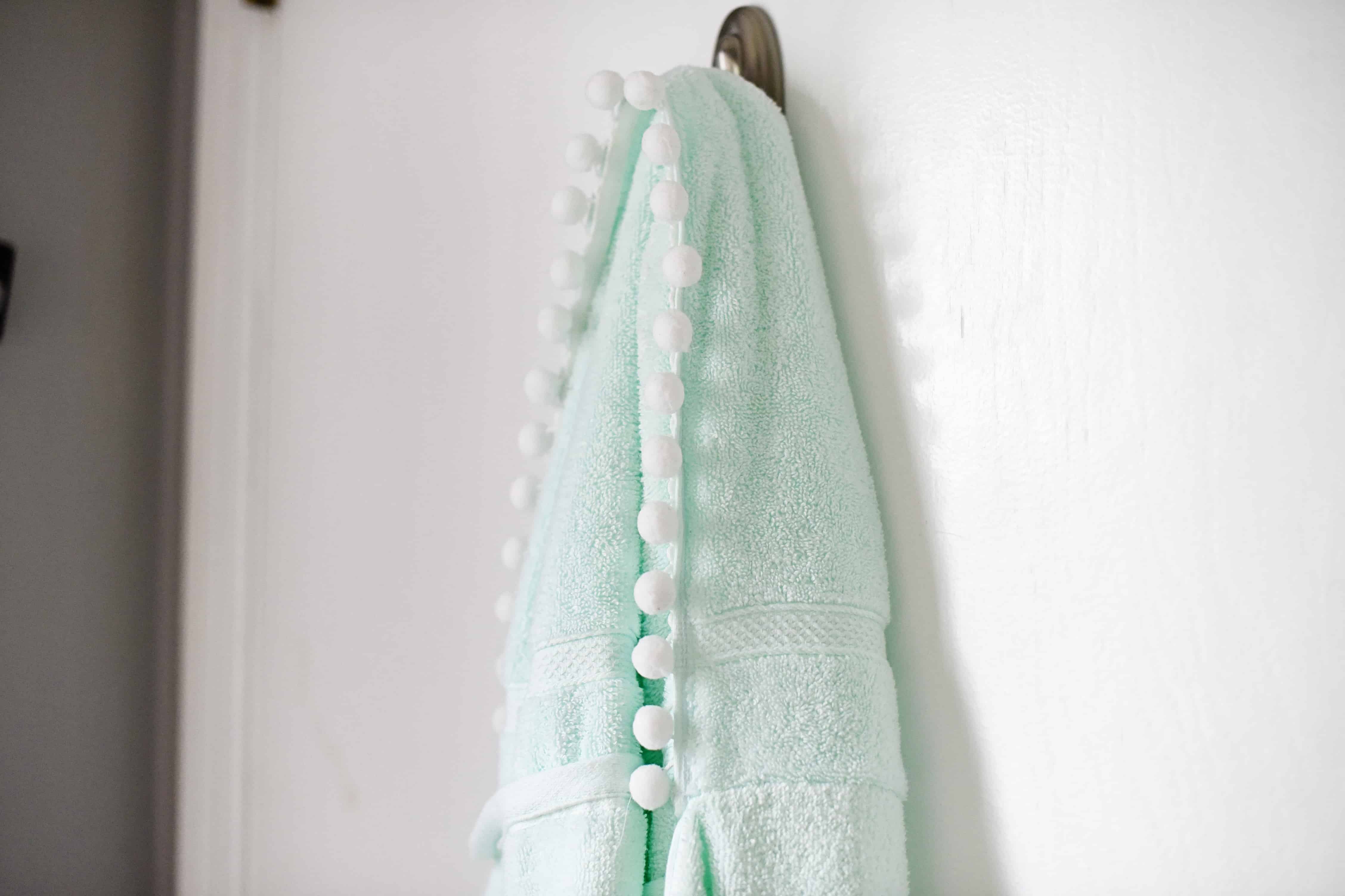 Learn how to make this easy and quick 15 minute DIY hooded towel for big kids. The pom pom trim really ups the cuteness factor!