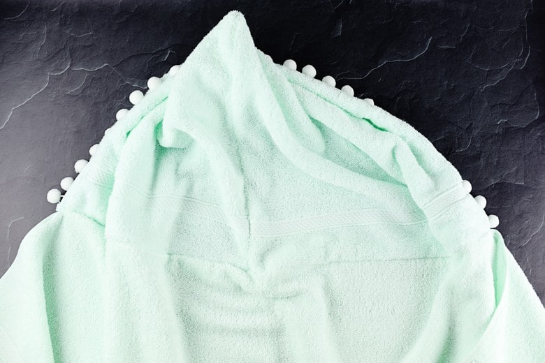 Learn how to make this easy and quick 15 minute DIY hooded towel for big kids. The pom pom trim really ups the cuteness factor!