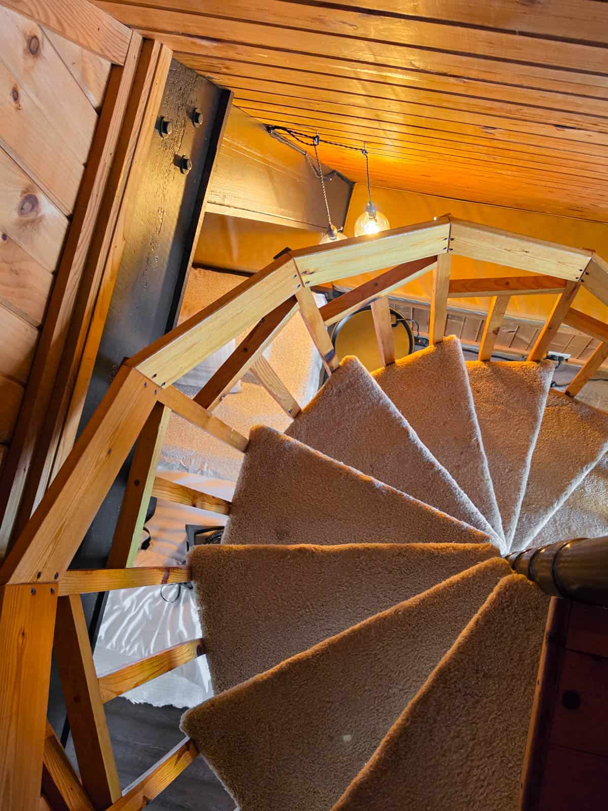 Spiral staircase inside the A-frame cabin leading between floors