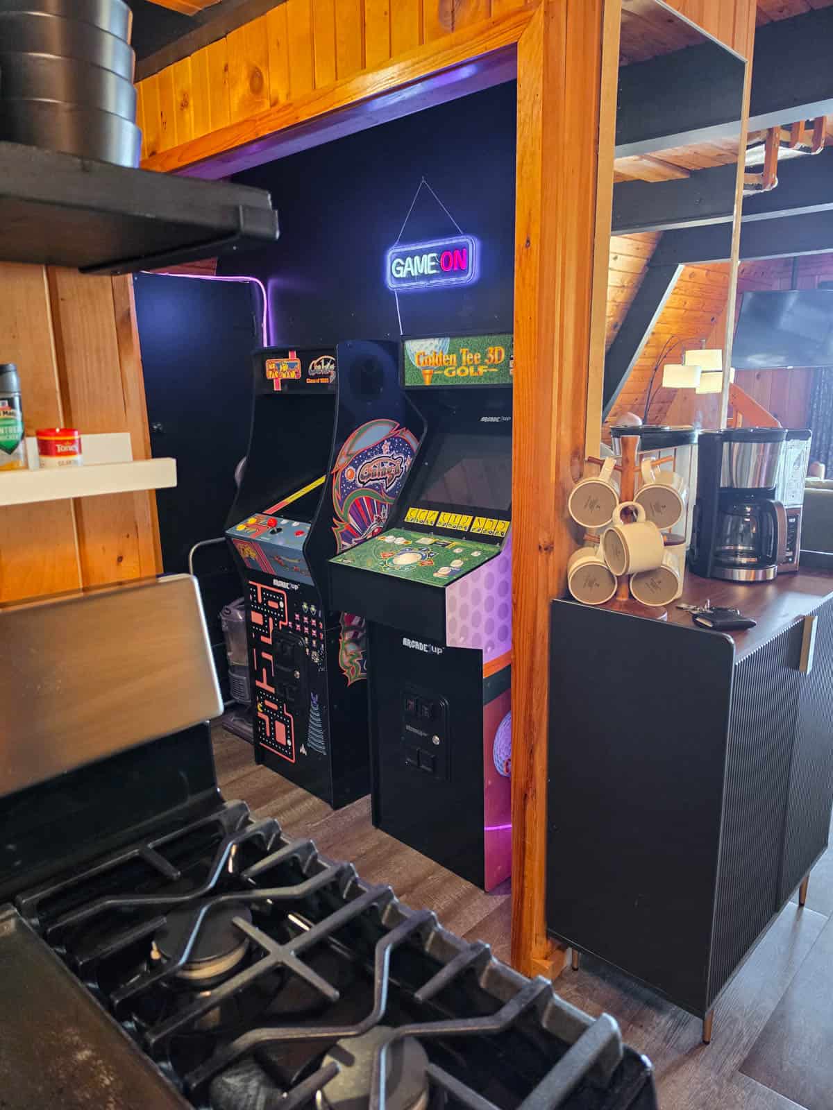 Arcade games beside the kitchen inside the Minnesota A-frame cabin