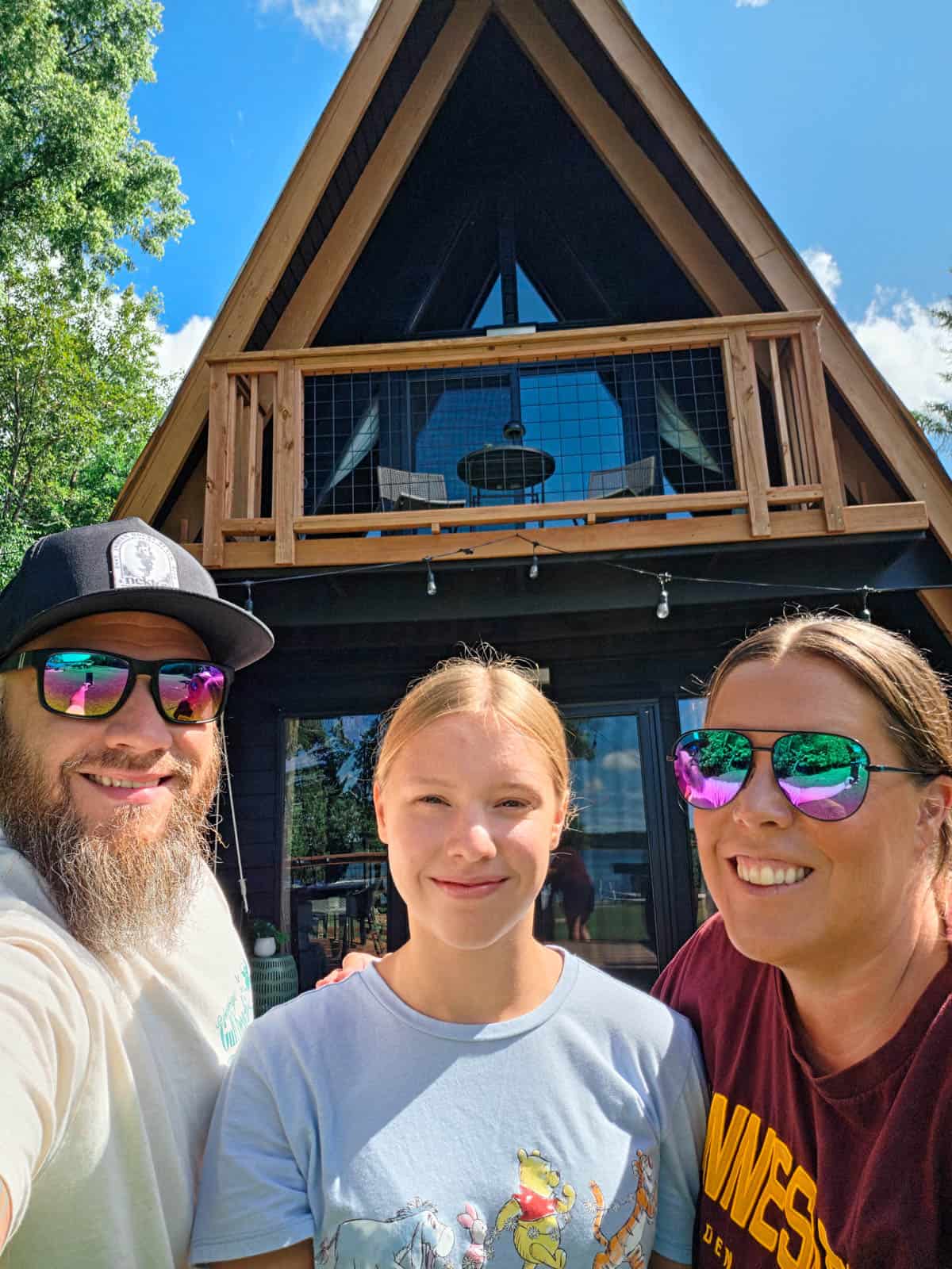 Family selfie in front of the Bass Lake A-frame cabin in Grand Rapids, Minnesota