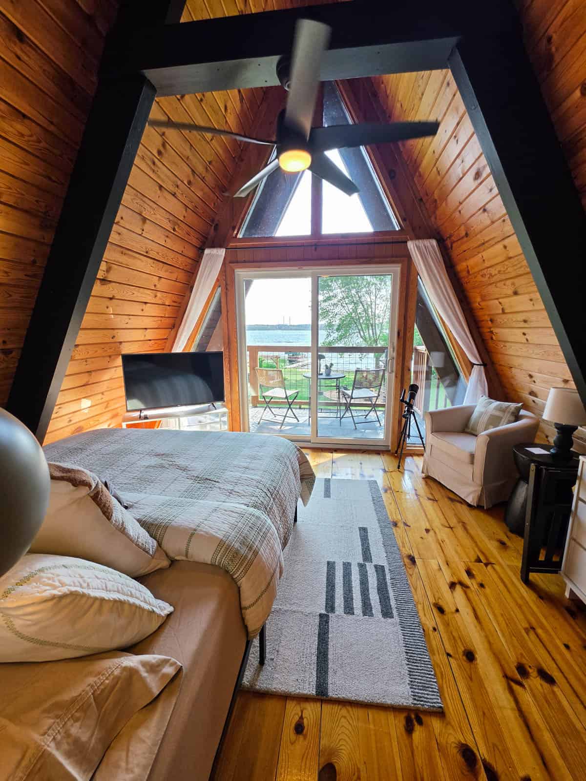 A-frame cabin bedroom with private balcony overlooking Bass Lake
