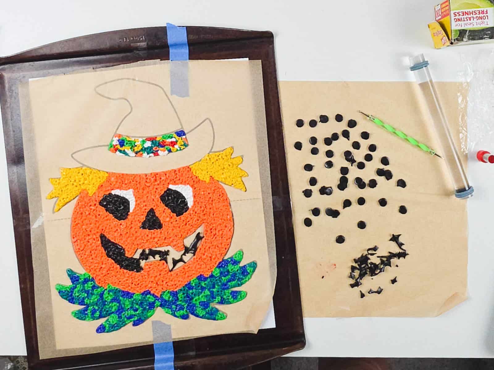 Unbaked polymer clay Halloween decoration resting on parchment paper on a baking sheet