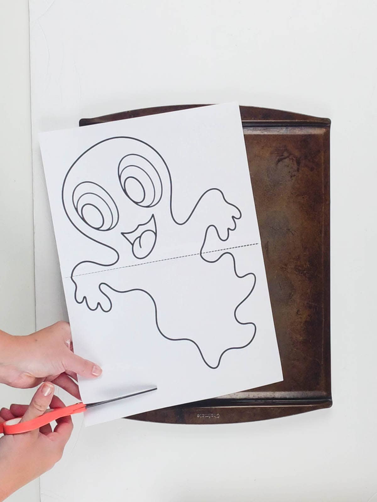 Printed Halloween popcorn decoration pattern taped together on a baking sheet