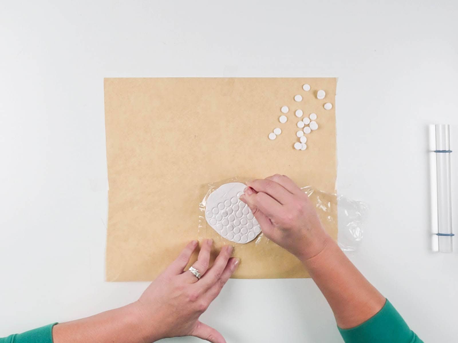 Small round cutter used to make polymer clay circles through plastic wrap